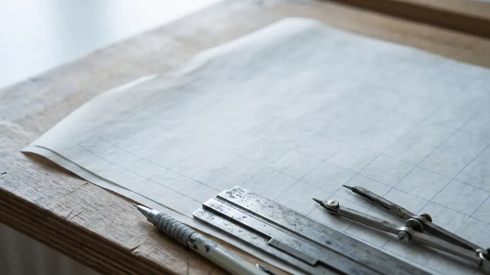 Drafting vellum on a board with a steel scale rule and dividers